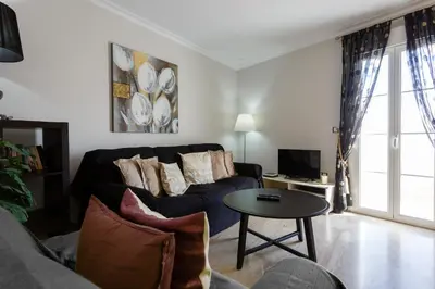a living room with a couch and a table at El Atico de los INGLESES by Cadiz4Rentals in Cádiz