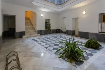 a lobby with a staircase and a checkered floor at El Atico de los INGLESES by Cadiz4Rentals in Cádiz