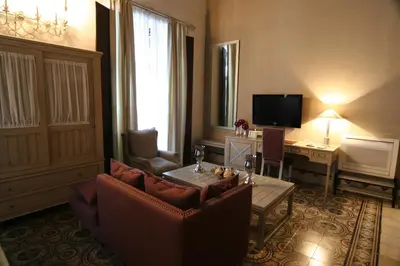 a living room with a couch and a table at Hostal Palacio San Bartolomé in El Puerto de Santa María