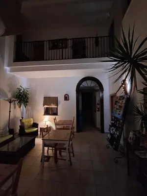 a living room with a table and a couch at Hostal Fenix in Jerez de la Frontera