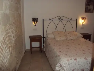 a bedroom with a bed and two night stands and lamps at Hostal Fenix in Jerez de la Frontera