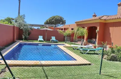 a swimming pool in the backyard of a house at Casa Maestro Roche in Roche