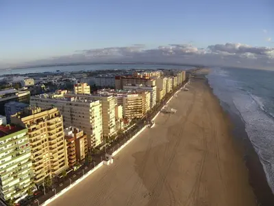 an aerial view of a beach with buildings and the ocean at Brisas Playa 3 Baños in Cádiz
