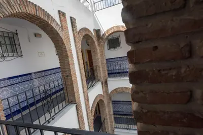 an alley in a building with arches and a wall at Hotel San Andres in Jerez de la Frontera
