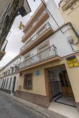 a building on a street with a balcony at Hotel San Andres in Jerez de la Frontera