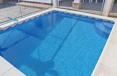 a large swimming pool with blue water at Chalet Peñuelas in Conil de la Frontera
