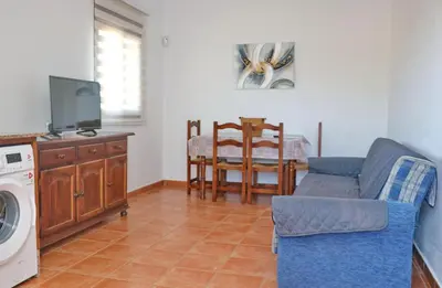 a living room with a couch and a washing machine at Chalet Peñuelas in Conil de la Frontera