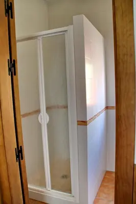 a shower stall with a glass door in a bathroom at Chalet Cala de Roche in Roche