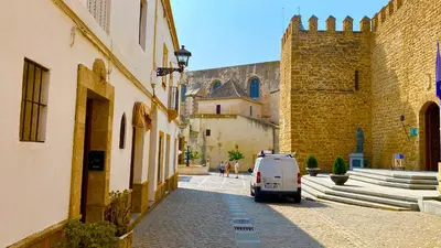 a small car parked on a street next to a building at Apartamento con Terraza,a 100m playa Costilla y Frente al Castillo in Rota