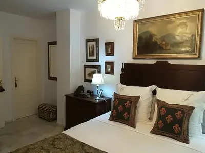 a bedroom with a bed and a painting on the wall at Rota playa Calle Puyana in Rota