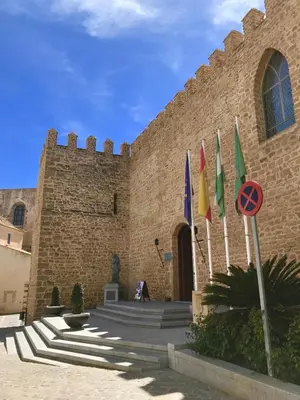 a building with flags in front of it at Rota playa Calle Puyana in Rota