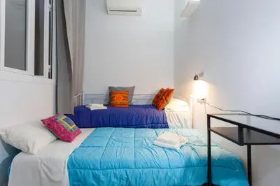 a bedroom with two beds with colorful pillows at La PEPA1812 by Cadiz4Rentals in Cádiz