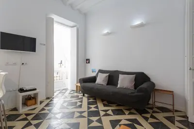 a living room with a couch on a checkered floor at La PEPA1812 by Cadiz4Rentals in Cádiz