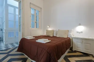 a bedroom with a bed with towels on it at La PEPA1812 by Cadiz4Rentals in Cádiz
