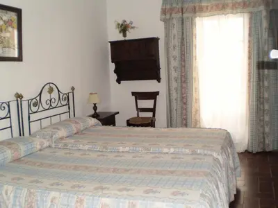 a bedroom with a bed and a window at Hostal Gran Capitan in Chipiona