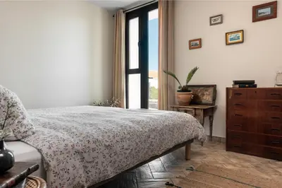 a bedroom with a bed and a dresser and a window at HACIENDA LAS MESAS - Luxury Villa Jerez in Jerez de la Frontera