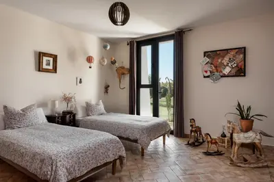 a bedroom with two beds and a window at HACIENDA LAS MESAS - Luxury Villa Jerez in Jerez de la Frontera
