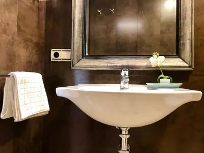 a white sink in a bathroom with a mirror at El Estudio del Marqués Little Apartments in Cádiz