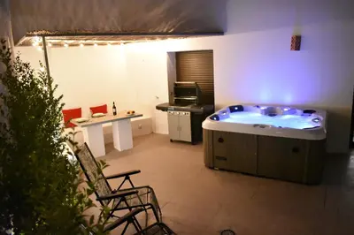 a large bathroom with a hot tub in a room at Home Apartments Jerez in Jerez de la Frontera