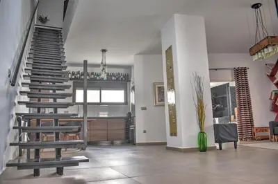 a living room with a spiral staircase in a house at Home Apartments Jerez in Jerez de la Frontera