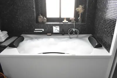a white bath tub with a cloud in the middle at Home Apartments Jerez in Jerez de la Frontera