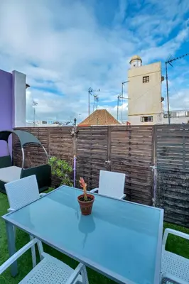 a blue table and chairs on a patio at Atico soleado y céntrico in Cádiz