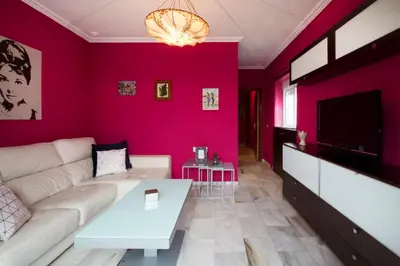a living room with a couch and a tv at Atico soleado y céntrico in Cádiz