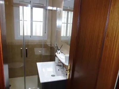 a bathroom with a sink and a glass shower at Atiko La Vista in Arcos de la Frontera