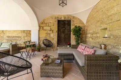 a living room with a couch and chairs and a table at Sherry Loft Siente Jerez Parking Incluido in Jerez de la Frontera