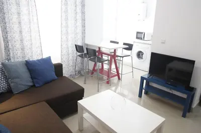 a living room with a couch and a table at Fantástico Piso, Junto a Playa y Pleno Centro in Cádiz