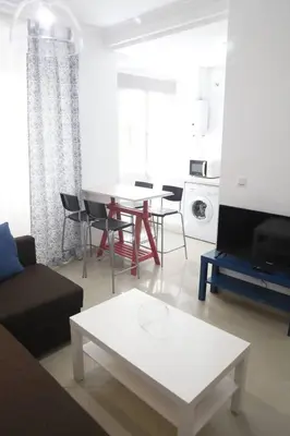 a living room with a couch and a table at Fantástico Piso, Junto a Playa y Pleno Centro in Cádiz