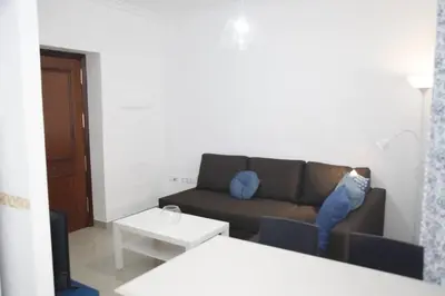 a living room with a couch and a table at Fantástico Piso, Junto a Playa y Pleno Centro in Cádiz