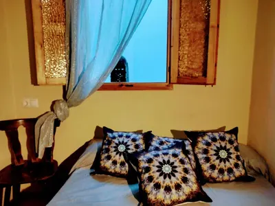 a bedroom with a bed with pillows and a window at Casa Salvadora in Algar