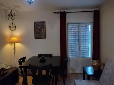 a living room with a table and chairs and a window at Casa Salvadora in Algar