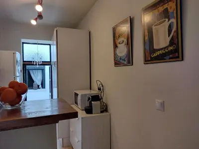 a small kitchen with a counter and a refrigerator at Casa Salvadora in Algar