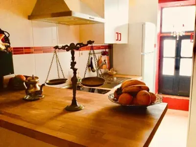 a kitchen counter with a bowl of fruit and a scale at Casa Salvadora in Algar