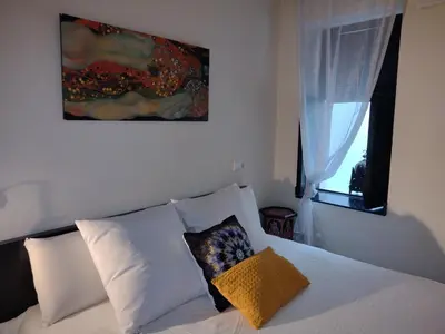 a bedroom with a bed with white pillows and a painting at Casa Salvadora in Algar