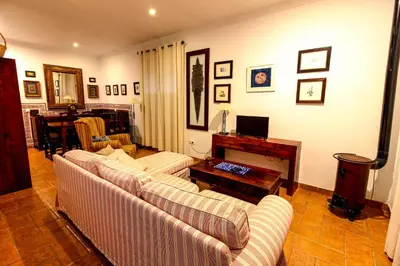 a living room with two couches and a fireplace at Los Candiles in Conil de la Frontera