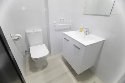a white bathroom with a toilet and a sink at Preciosa Oportunidad, Junto a Playa y Teatro Falla in Cádiz