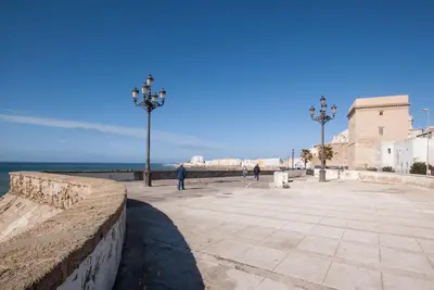 a plaza on the beach with the ocean in the background at Gades Suite in Cádiz