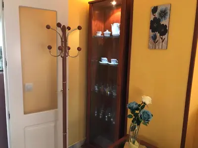 a room with a glass door and a shelf with glasses at Casa Bahía de Cádiz in Puerto Real