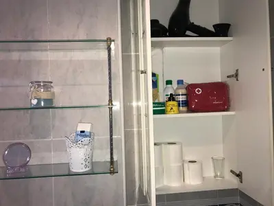 a bathroom with a shelf with toiletries on it at Casa Bahía de Cádiz in Puerto Real