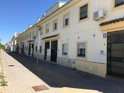 a row of white buildings on a street at Casa Bahía de Cádiz in Puerto Real