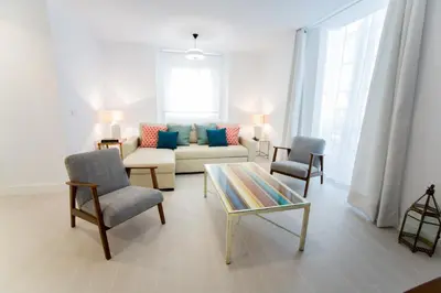 a living room with a couch and two chairs and a table at Apartamento Rosario 49 in Cádiz