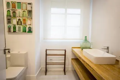 a bathroom with a sink and a toilet and a window at Apartamento Rosario 49 in Cádiz