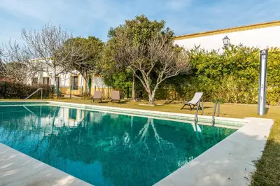 a swimming pool in front of a house at Vivienda Rural Olivar de San Telmo in Arcos de la Frontera