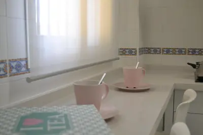 a kitchen with two cups and plates on a counter at Sherryflat Alcázar - Parking in Jerez de la Frontera
