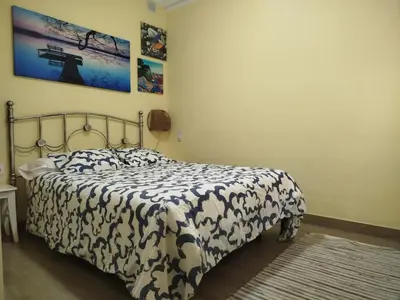 a bedroom with a bed with a black and white comforter at Casas Lomas II in Arcos de la Frontera