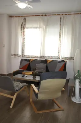 a living room with a couch and a table and chairs at Casas Lomas II in Arcos de la Frontera