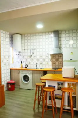 a kitchen with a table and stools in it at Casas Lomas II in Arcos de la Frontera